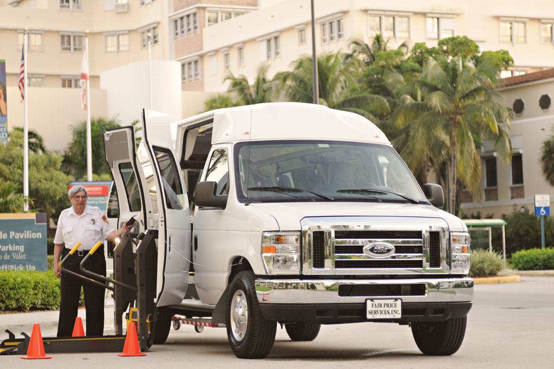 A wheelchair-accessible van with a driver and lift